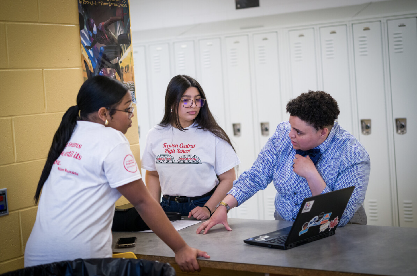 Teacher assisting students.